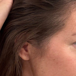 Close-up of a person with hair partially covering their face